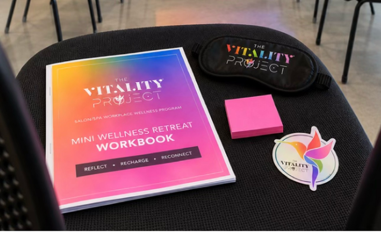 A seat set with a workbook, sticky notes, a sticker and an eye mask